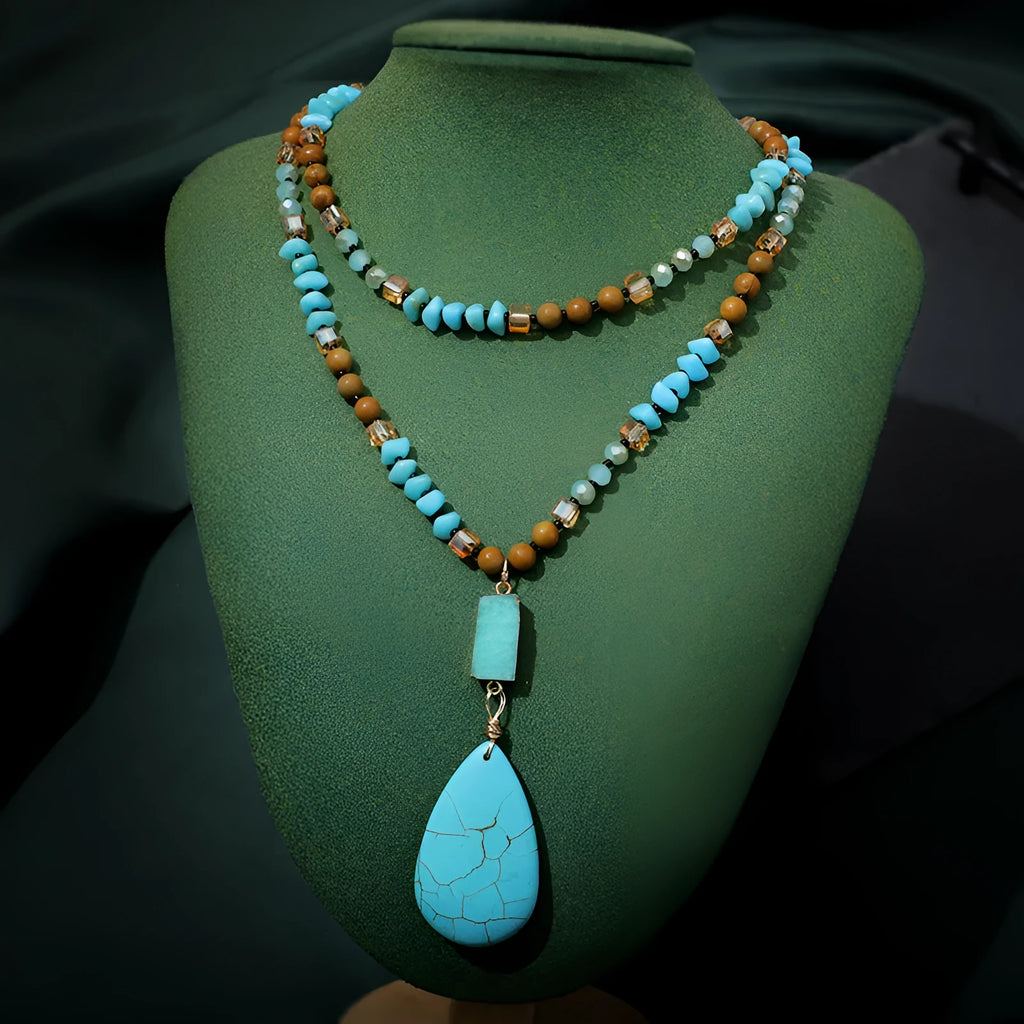 Long blue turquoise imitation mineral pendant necklace with a geometric setting on a ball bead chain.