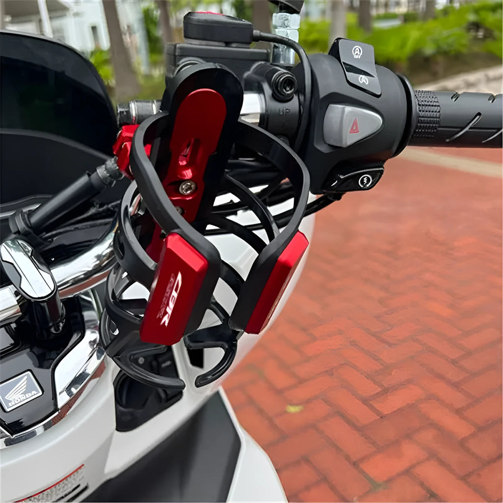 Black plastic water bottle cage mounted on Honda X-ADV scooter modified bumper