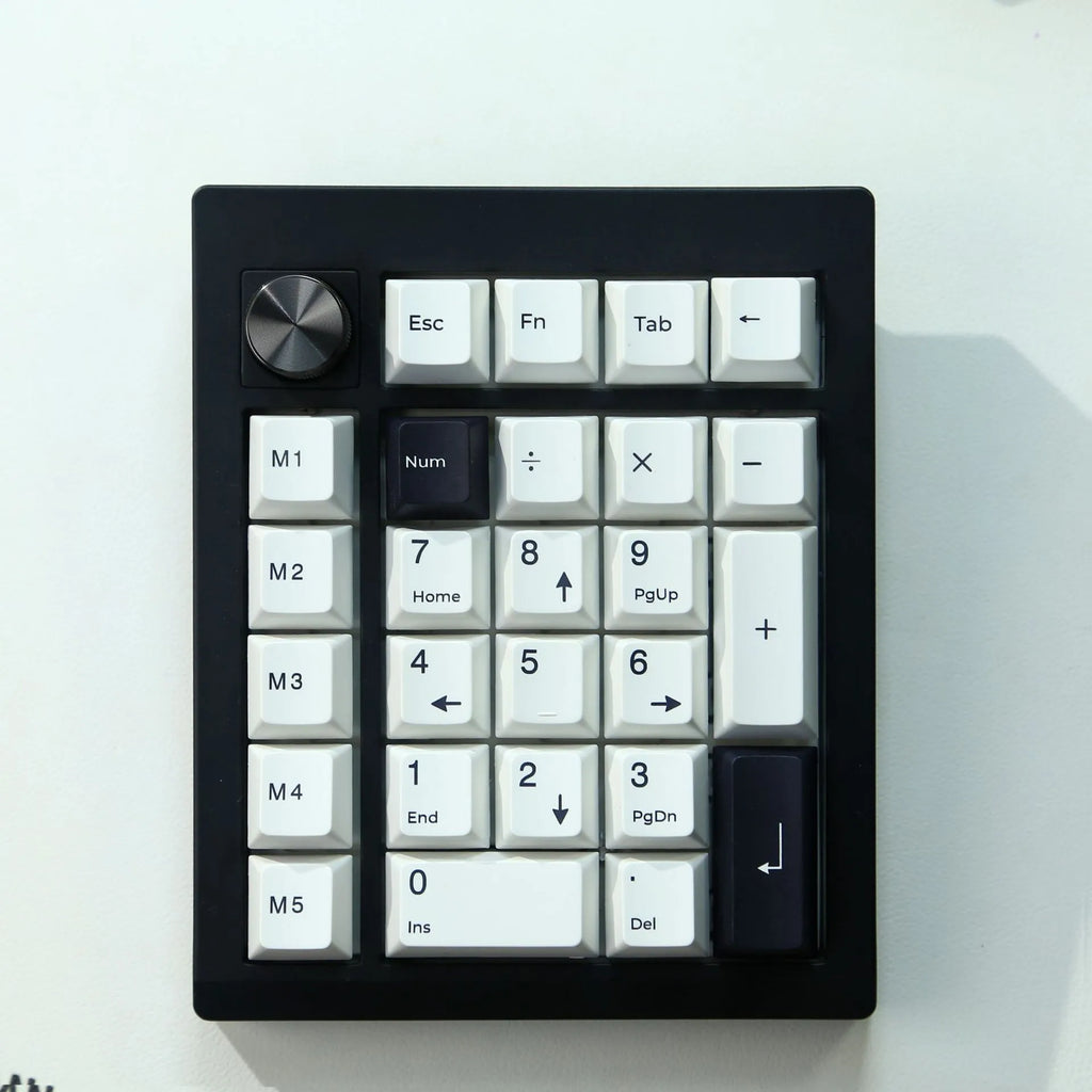 Black and white wireless Bluetooth mechanical numeric keyboard on a desk.