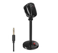 Black USB computer microphone with adjustable stand on desk for recording