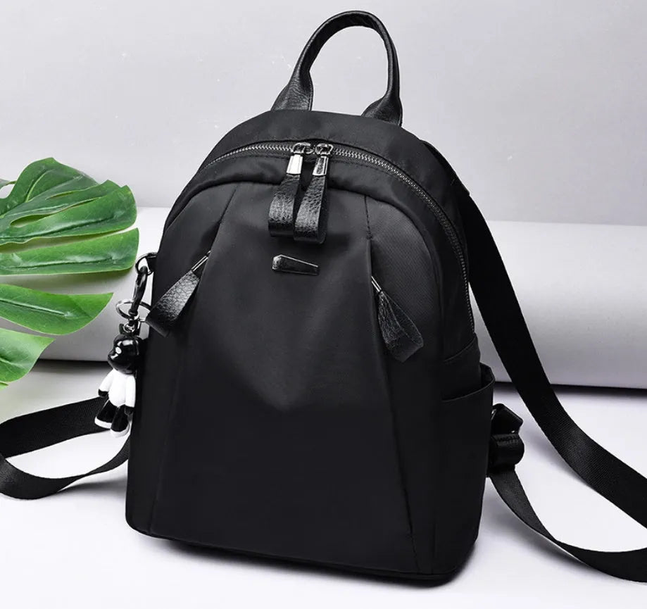Medium square fashion rucksack in Oxford cloth, shown in red, with internal phone and ID pockets.