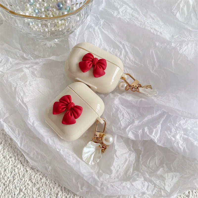 Beige red bow shell patterned TPU protective case for Apple AirPods Pro and AirPods 1, 2, 3 wireless earphones.