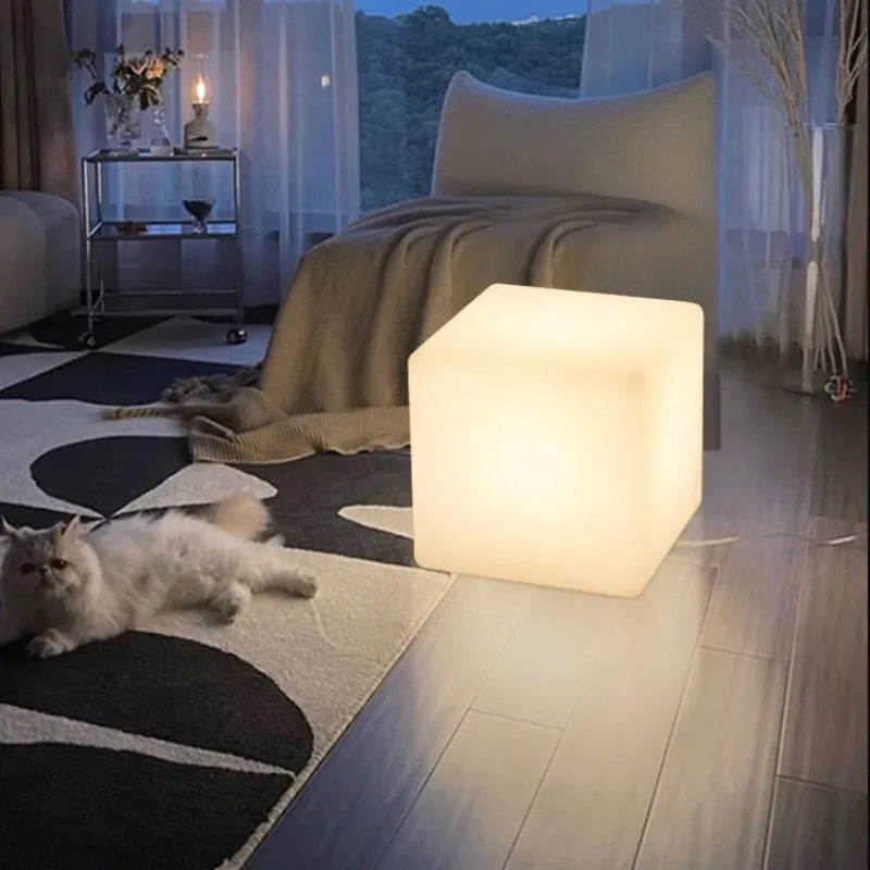 Modern LED illuminated cube stool in outdoor garden setting showing waterproof construction and integrated lighting