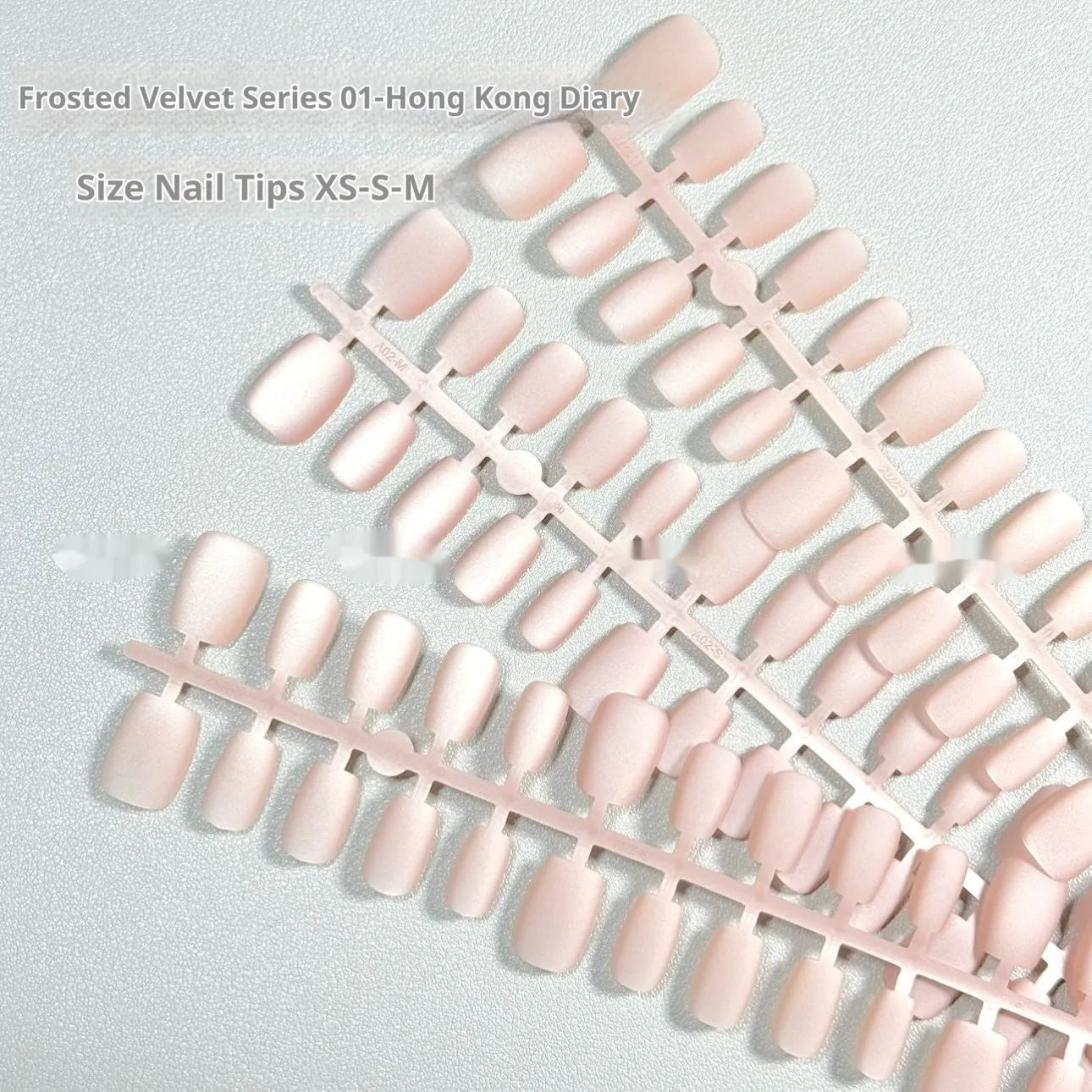 Frosted Velvet Cat's Eye false nail set showing Aurora armour design on short ladder shaped nails in sizes XS, S, and M.