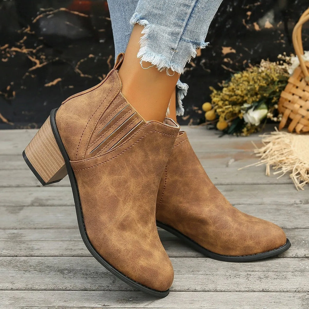 Women's black ankle boots with pointed toe, thick square heel and slip-on design
