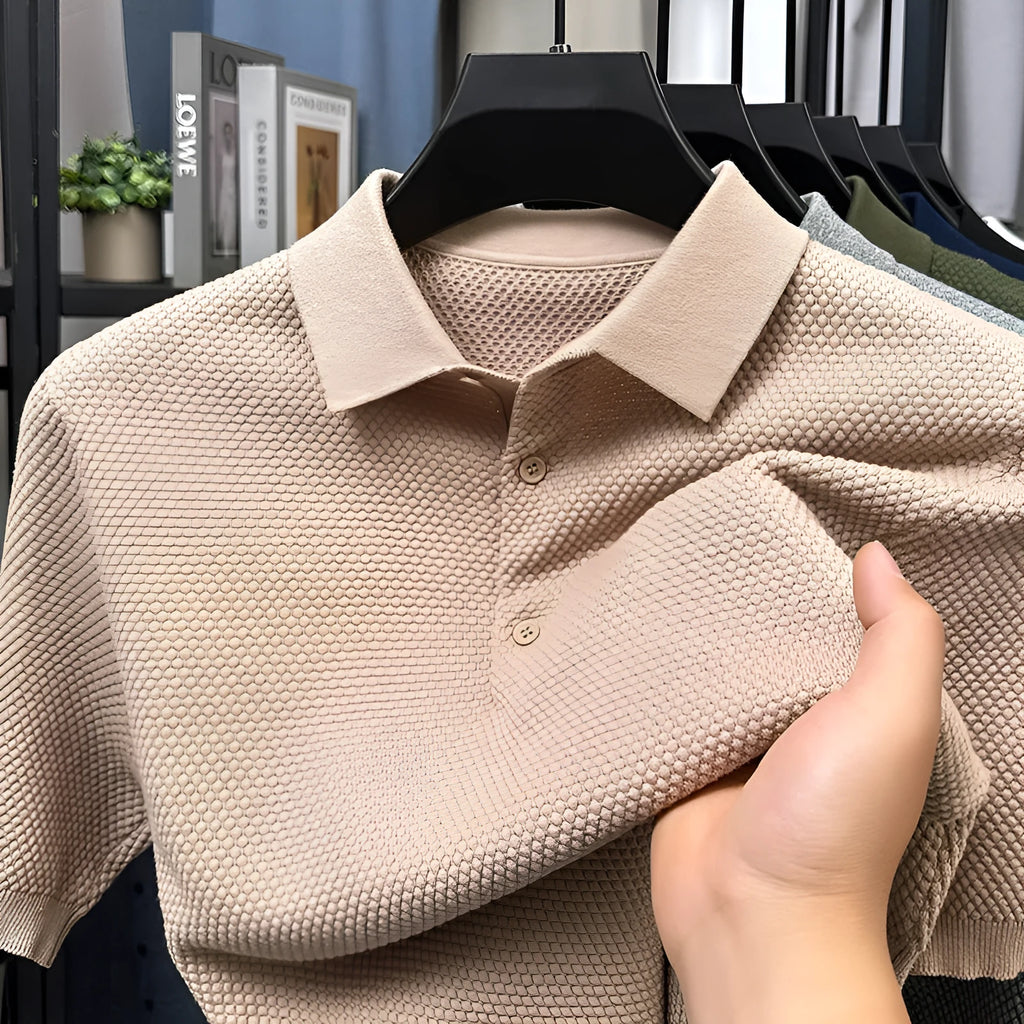 Man wearing a loose grey short sleeve cotton sweater, casual pullover style