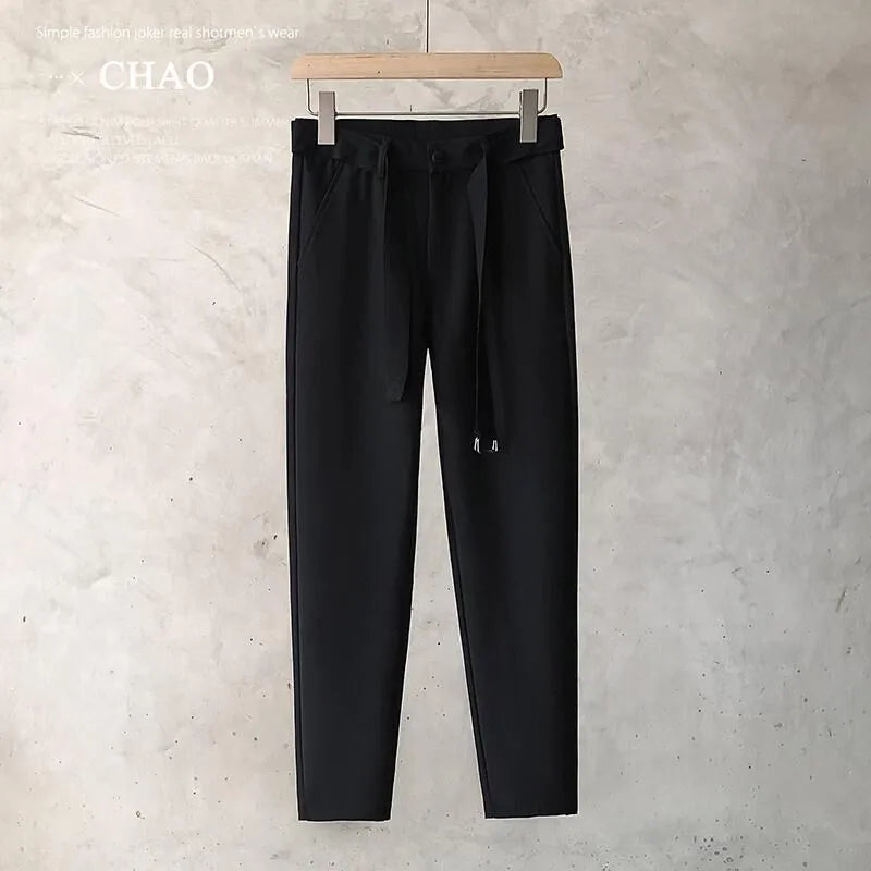 Boys slim straight wool trousers in black showing tapered cut and straight leg opening