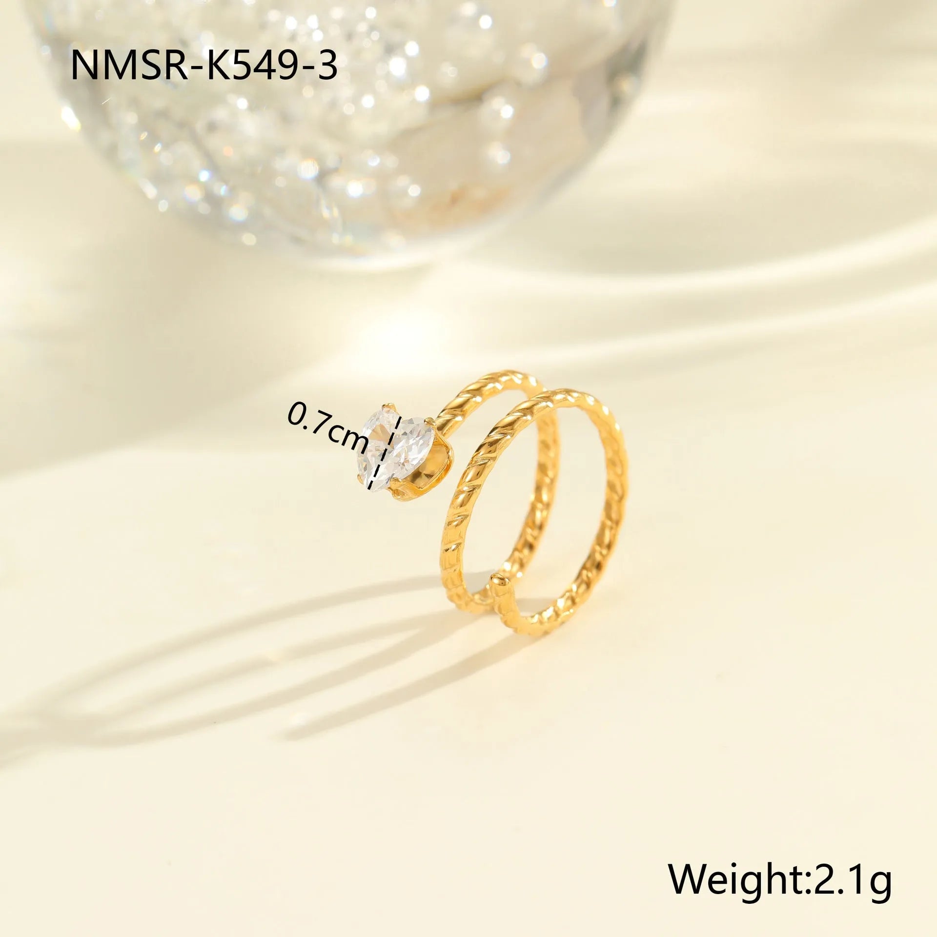 Gold electroplated geometric stainless steel ring with inlaid zircon stones on a finger, showing open mouth design.