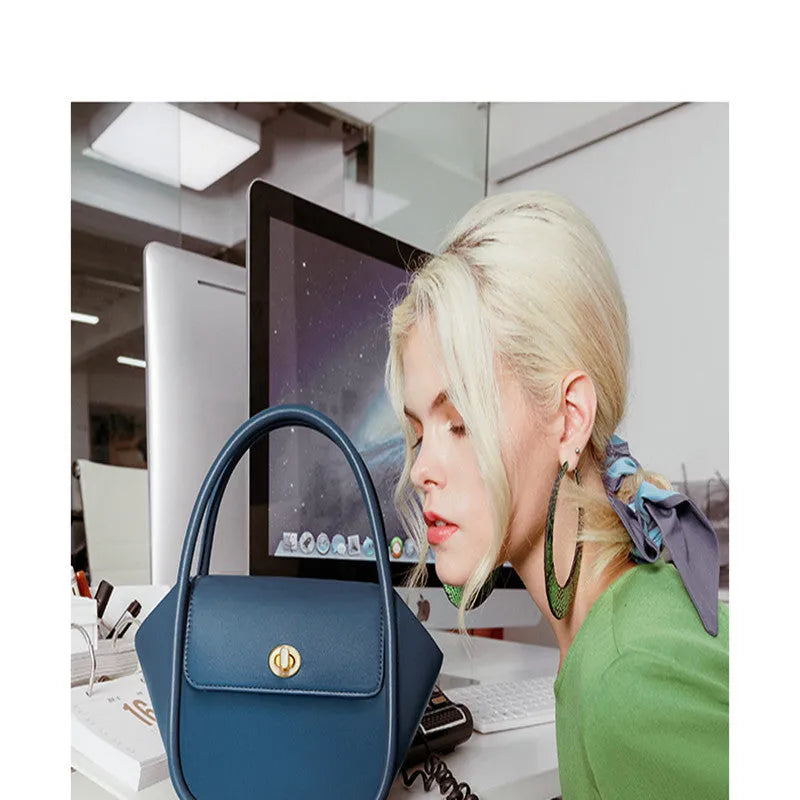 Women's wing-shaped cow leather tote handbag with a buckle closure in a choice of four colours.