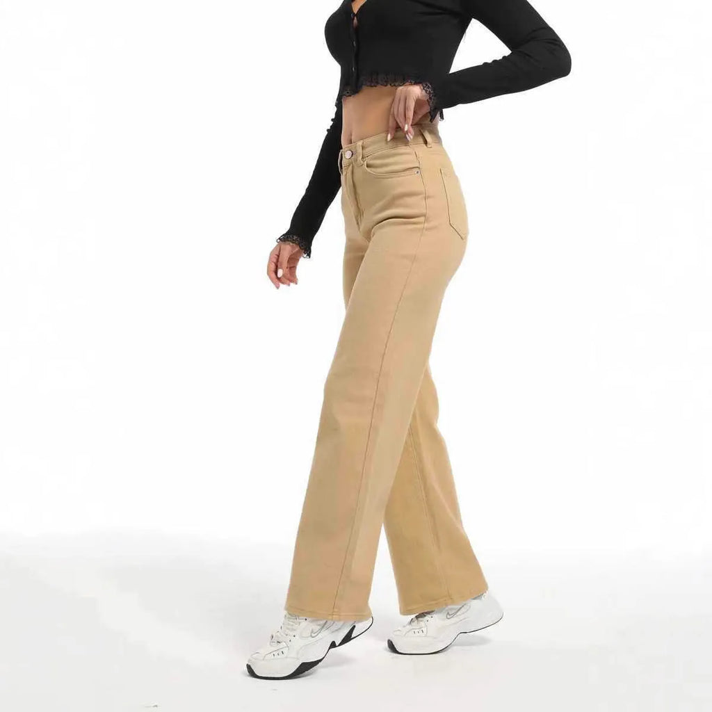 Women's high waist wide leg jeans in apricot colour on a hanger.