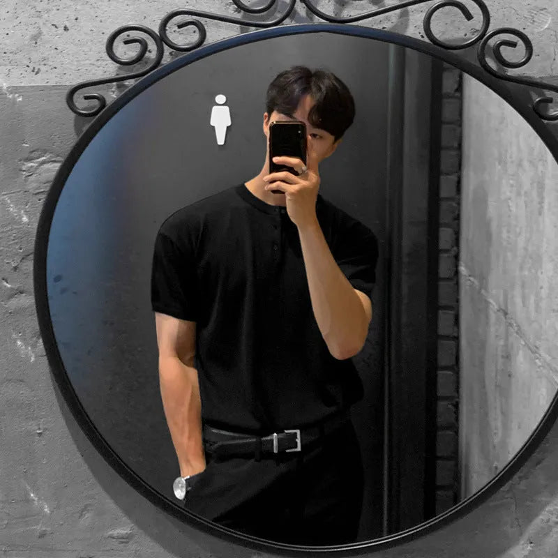 Man wearing a black thin slim-fit ice silk knitted short-sleeved bottoming shirt.