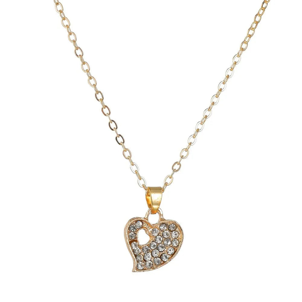 Women's gold alloy jewellery set with earrings, necklace featuring love pendant, and matching bracelet