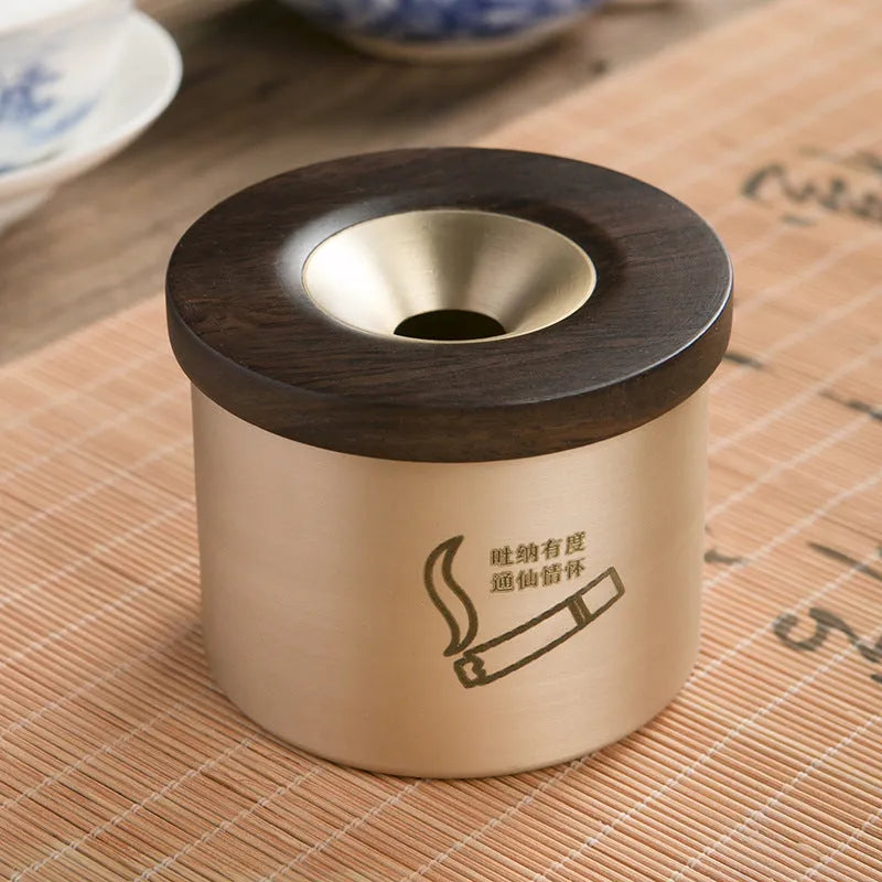 Retro brass and copper ashtray with wooden lid on a living room table.