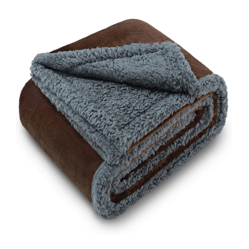 Pet waterproof blanket in beige flannel on a sofa with a dog lying on it