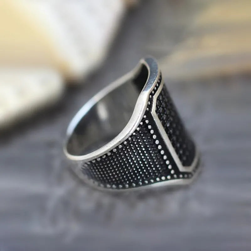 Black alloy ring with copper detailing around zircon stone on finger, showing European American jewellery style