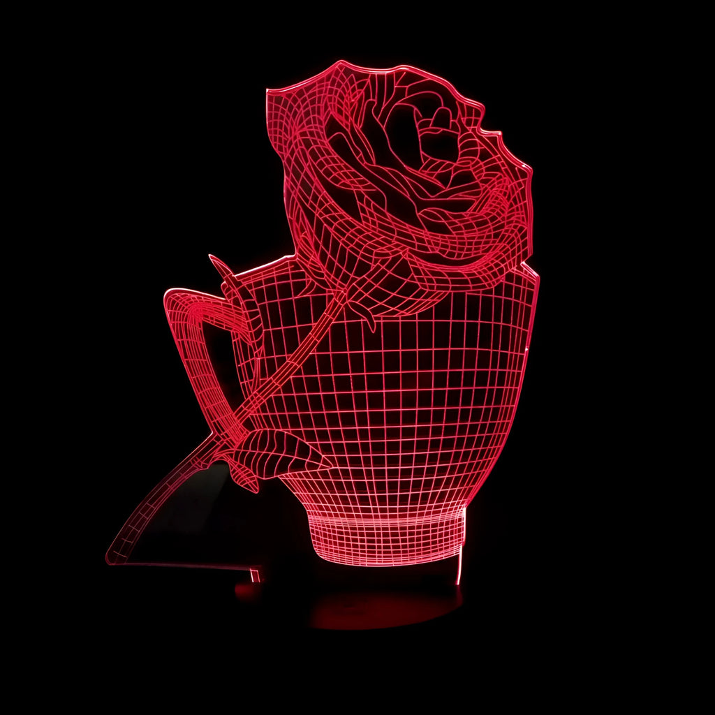 3D rose flower night light with colour-changing LED and remote control on a black base.