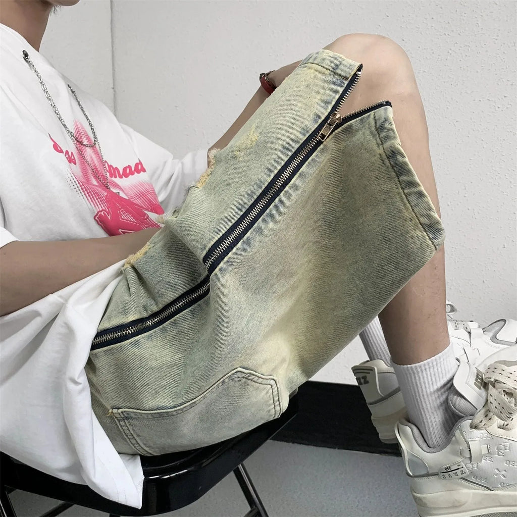 Men's blue denim shorts with loose five-point cut and yellow mud ripped detailing, button fly, straight leg