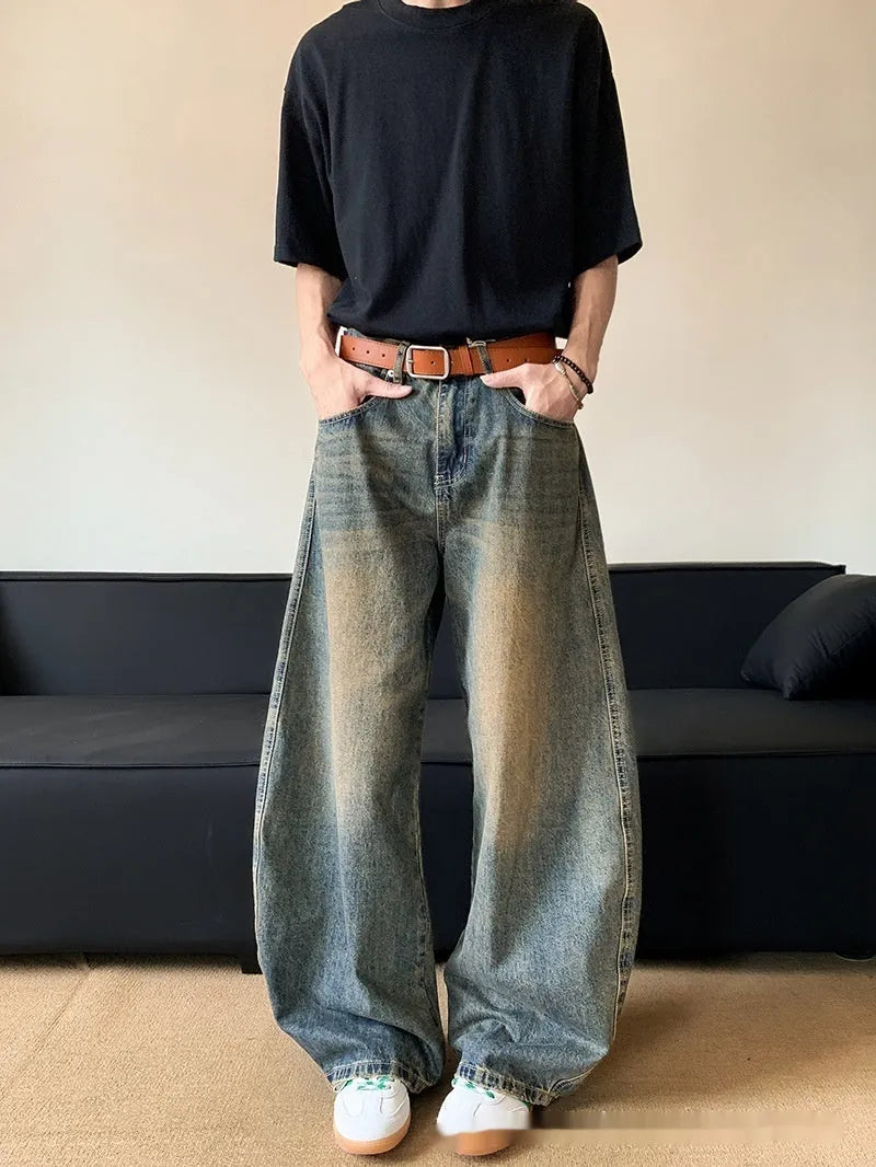 Men's retro blue distressed wide-leg jeans with a slimming fit through hips and thighs.