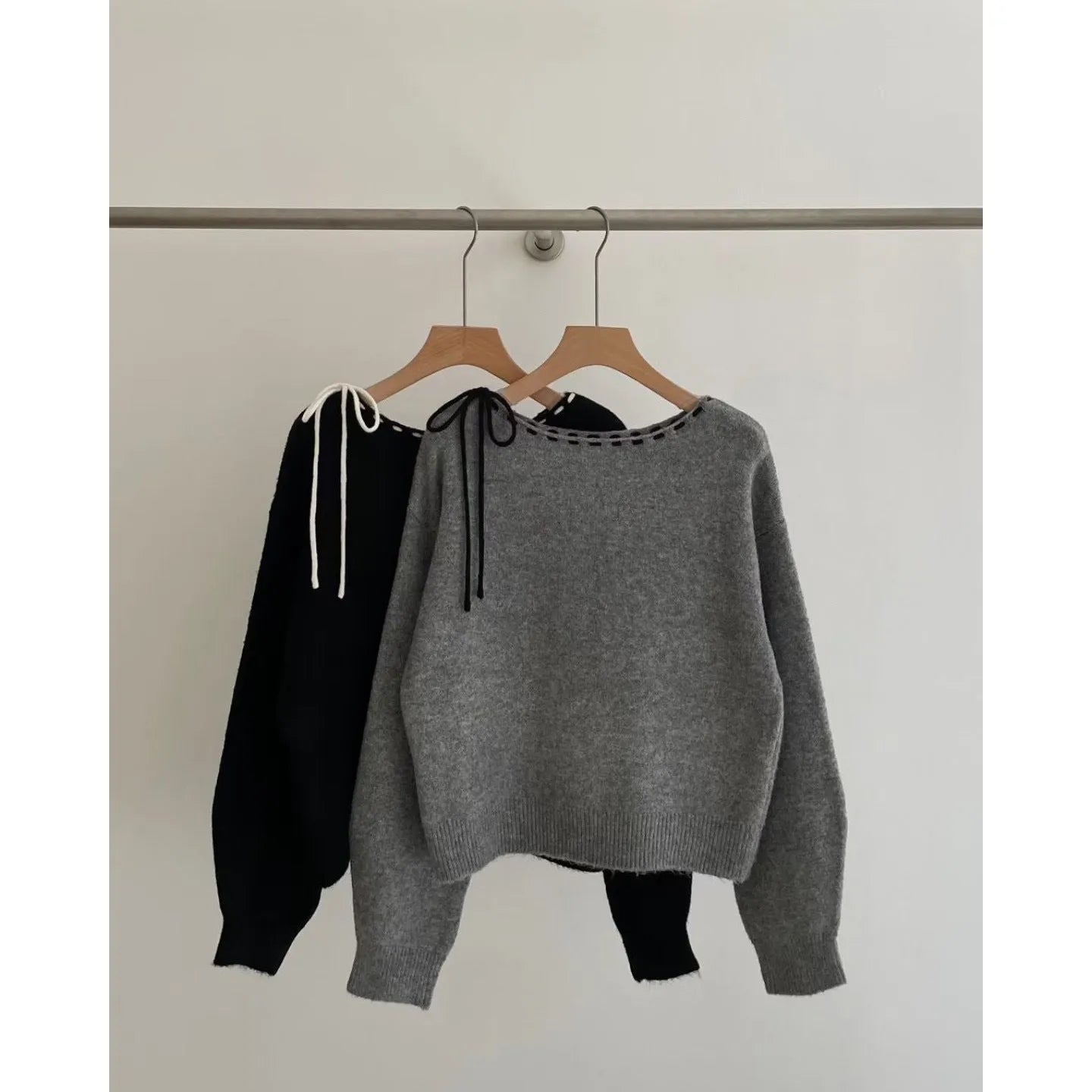 Grey loose-fitting women's knitwear pullover sweater on a hanger