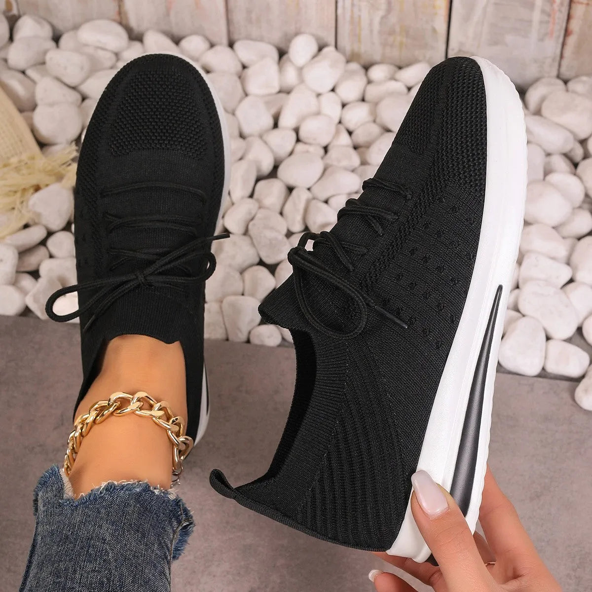 Women's red fly-knit low-top sneakers with round toe and front lace-up closure on artificial PU upper