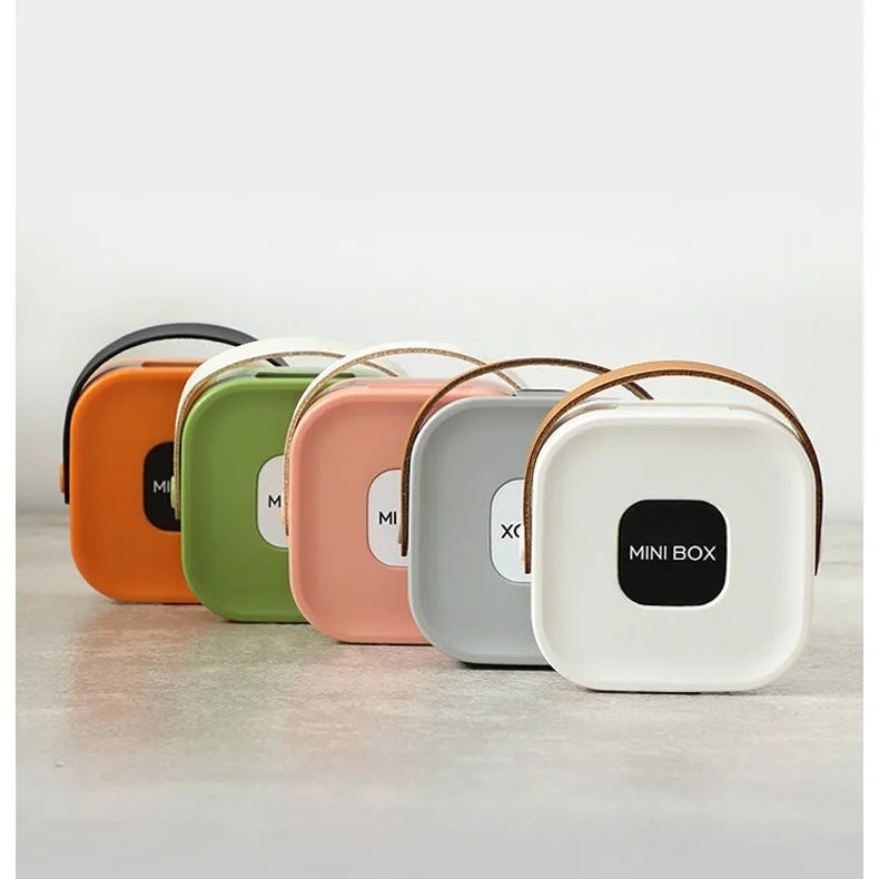 Medium-sized polypropylene storage box with a lid for organising cables and a Bluetooth headset.