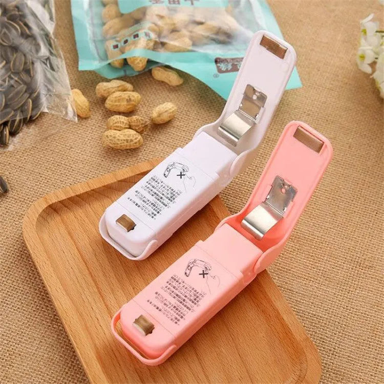 Household food clip portable mini plastic bag sealer heat sealing machine in pink on white background