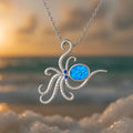 Geometric silver stainless steel octopus necklace with a blue opal inlay pendant on a box chain.