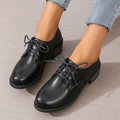 Black women's work shoes with a thick chunky heel and pointed toe.