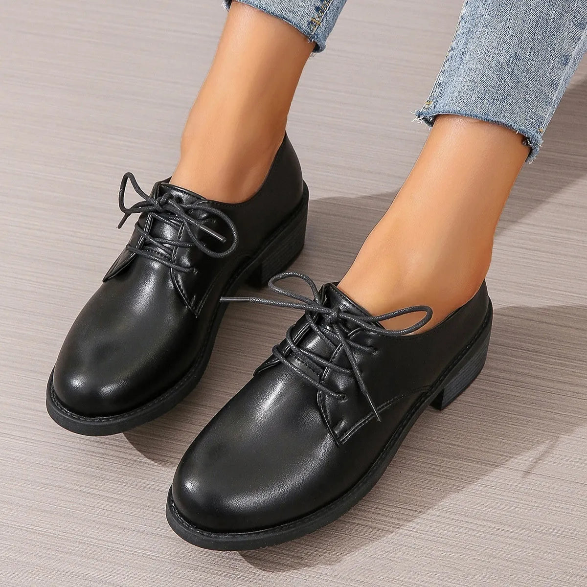 Black women's work shoes with a thick chunky heel and pointed toe.
