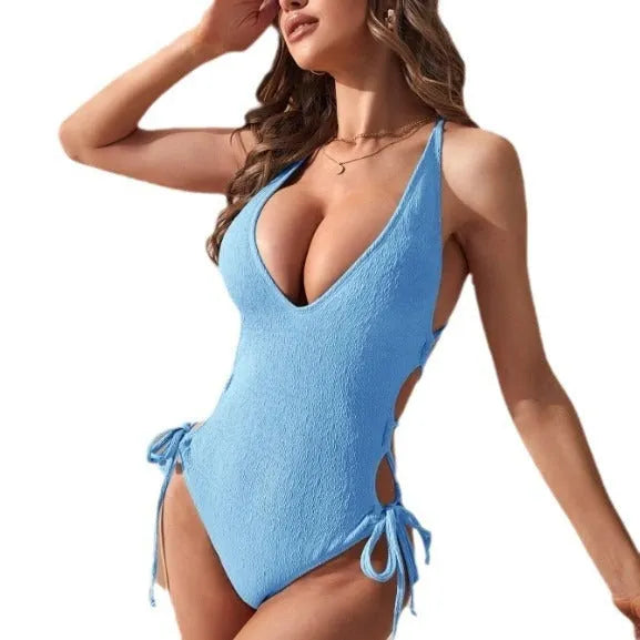 Women's black hollow backless tether one-piece swimsuit on a mannequin