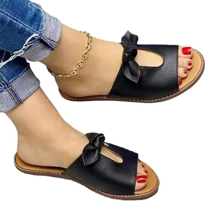 Women's black casual sandals with a fish mouth open toe and a decorative bow on the upper.