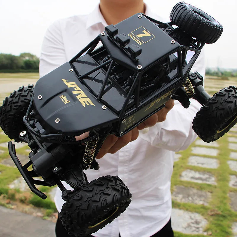 Large black 2.4G remote control four-wheel drive off-road climbing car on rough terrain