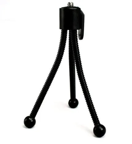 Small iron frame desktop mini tripod with telescopic legs and black ball head, shown next to a mobile phone.