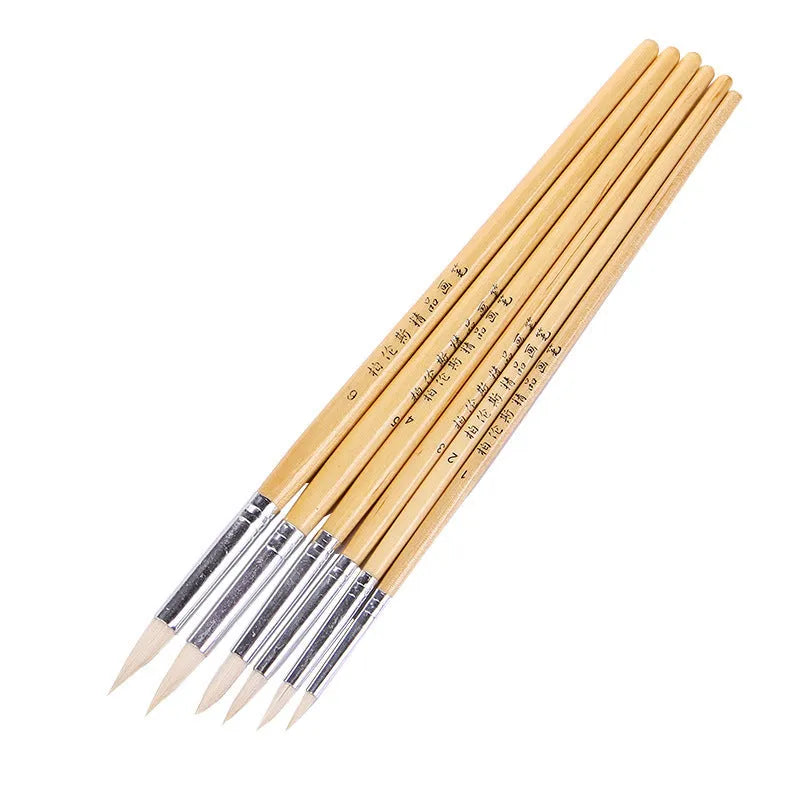 Six wooden-handled pointed wool line pen brushes arranged together.
