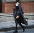 Long grey knitted cardigan coat with a hood, shown in a loose fit.
