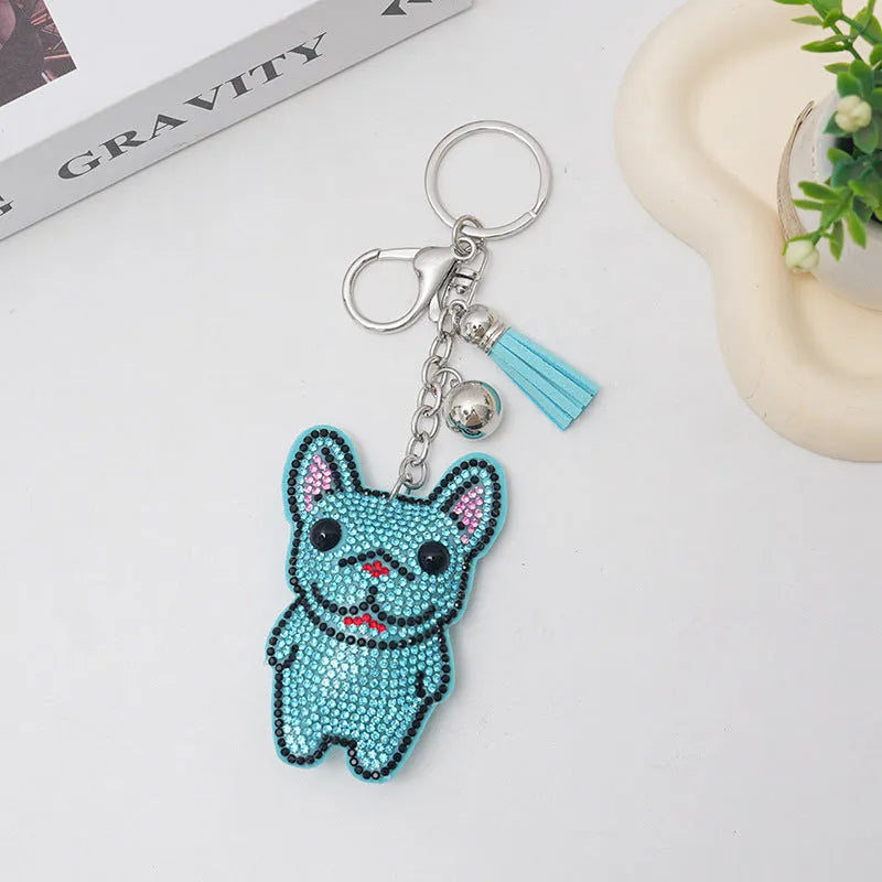 Close-up of a sparkling rhinestone French dog animal keychain charm in caramel colour.