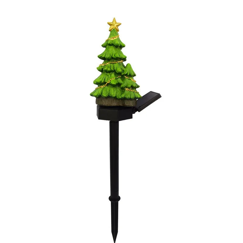 Solar Christmas tree ground plug light with resin body, warm white LED, and 40x40mm solar panel on a lawn