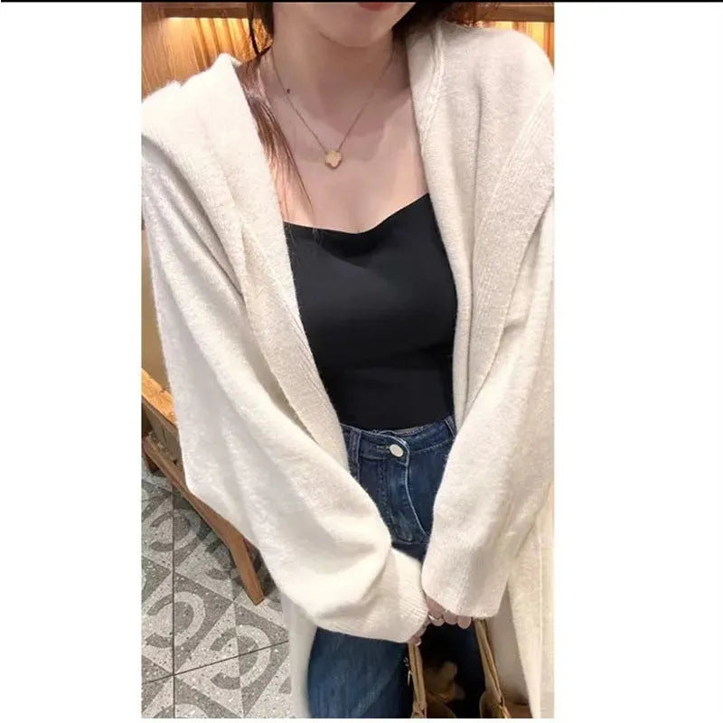 Long brown hooded knitted cardigan for women in a loose, below-the-knee fit.