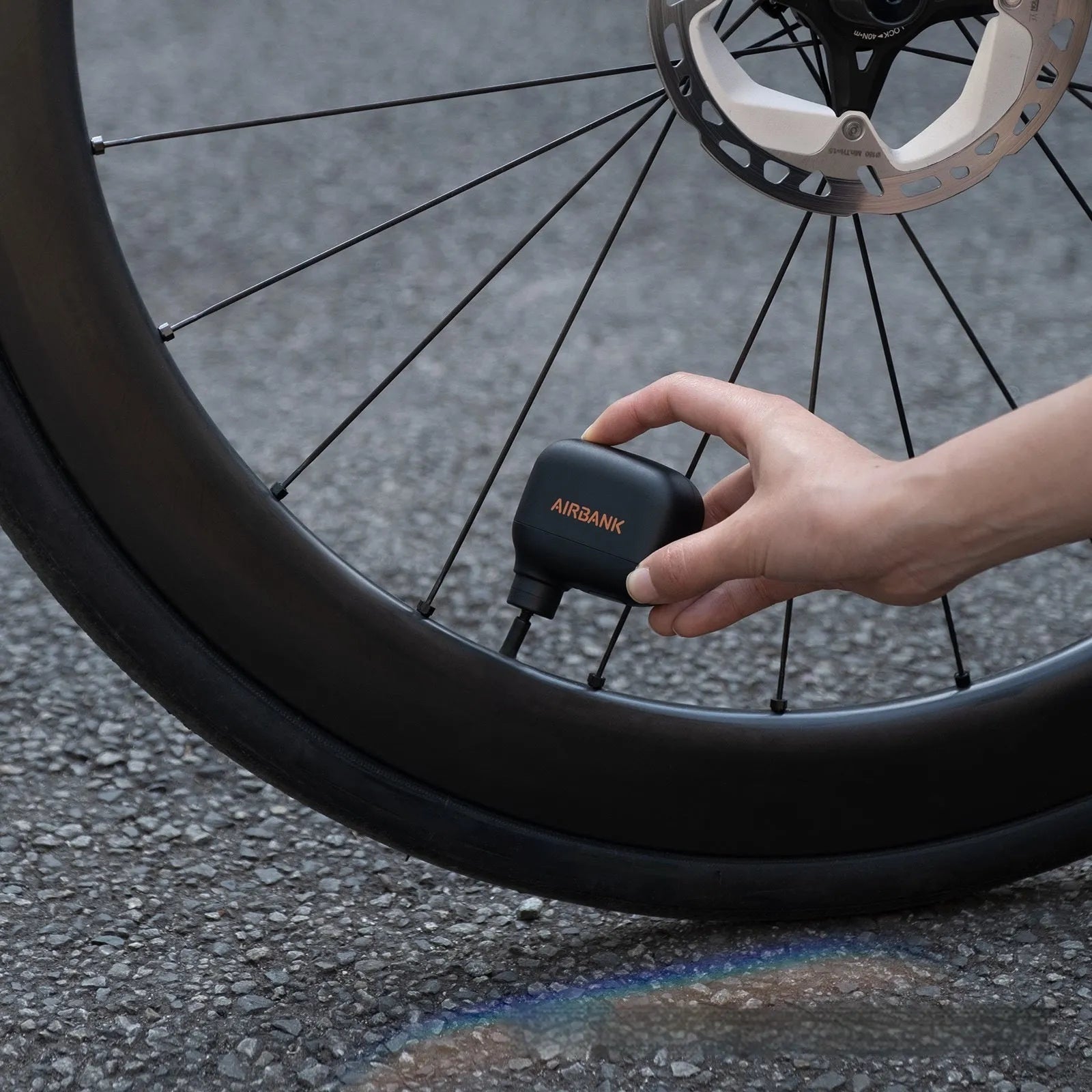 AS100 black mini electric bike pump with USB charging cable and waterproof bag