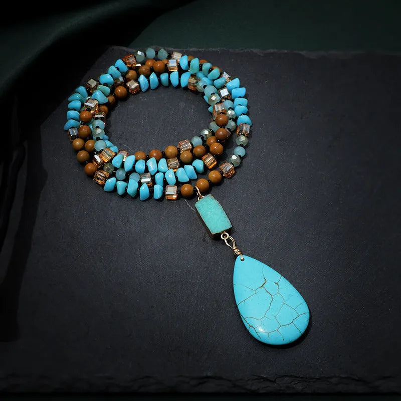 Long blue turquoise imitation mineral pendant necklace with a geometric setting on a ball bead chain.