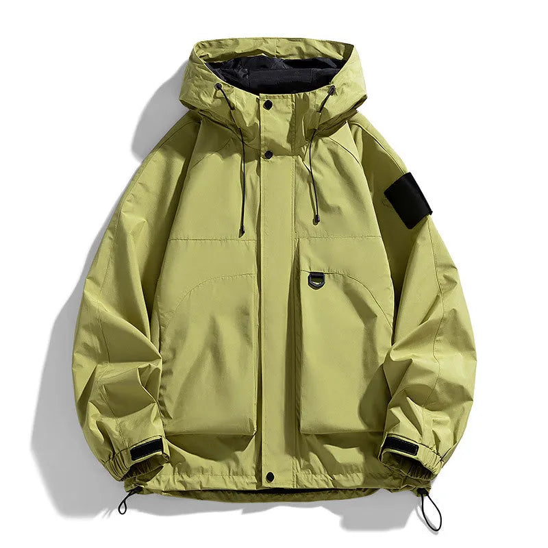 A man wearing a black windproof waterproof hooded jacket made from polyester blend fabric.
