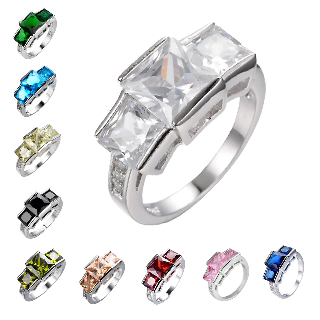 A selection of colourful electroplated copper rings in geometric designs, showing various sizes and hues.