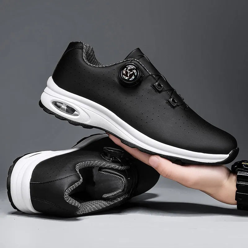 Black and white low top mesh tennis shoes with a round toe and flat composite sole on a plain background.