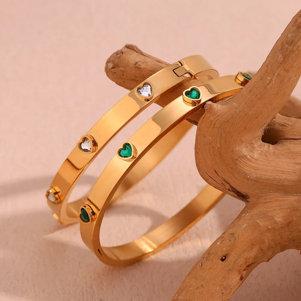 Golden electroplated stainless steel bracelet with a micro-inlaid peach heart charm for women.