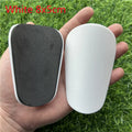 Extra small mini football shin guards measuring 8x5cm in black and white plastic
