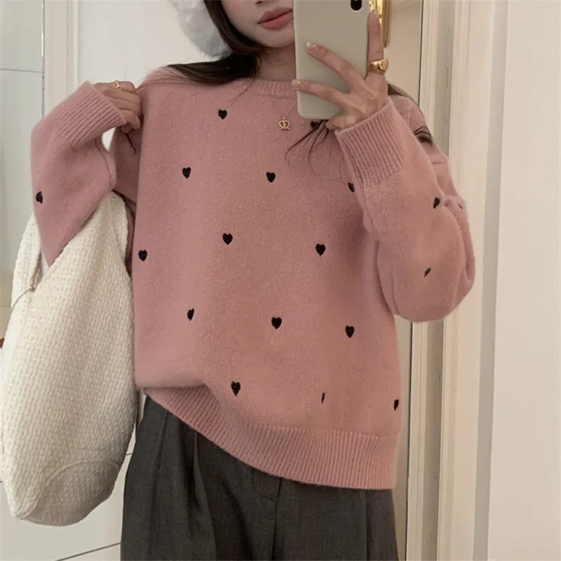 Women's loose grey acrylic pullover sweater with love pattern embroidery on the front.