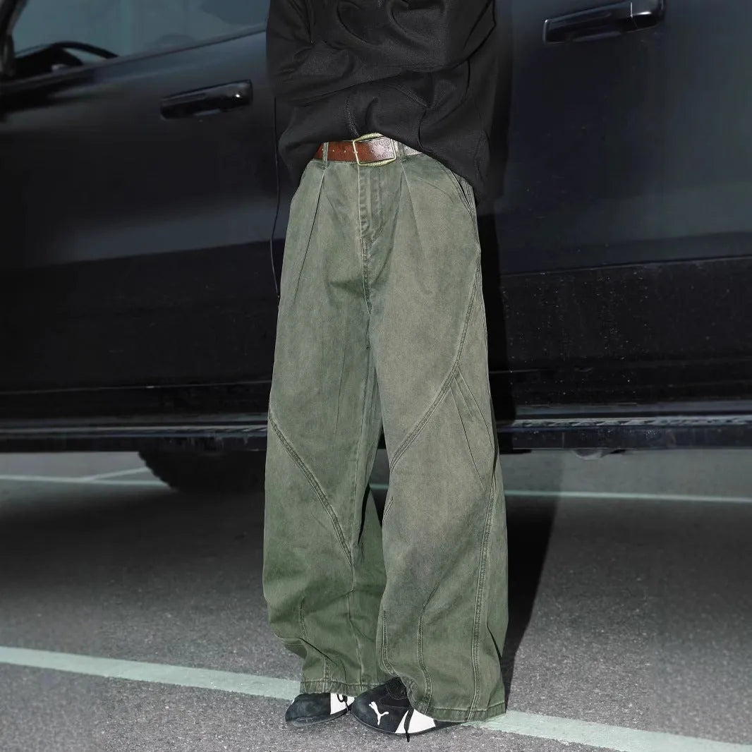 Men's pleated straight leg loose fit trousers in a black stripe pattern, showing front and side details.