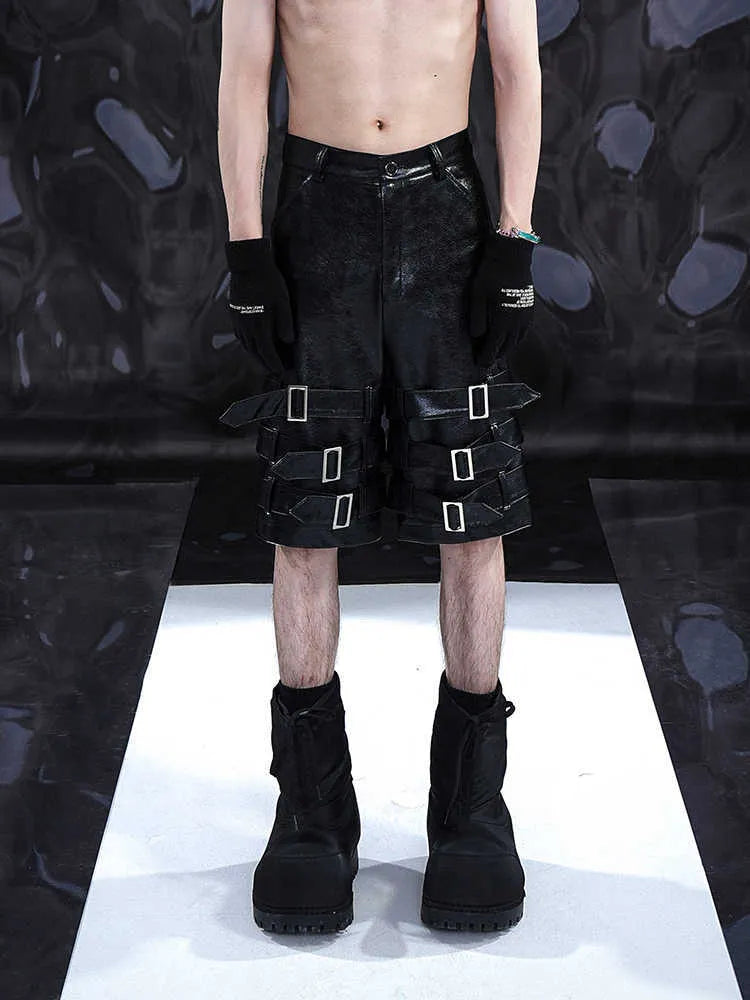 Men's black PU leather cropped shorts with leather ring details on a mannequin.