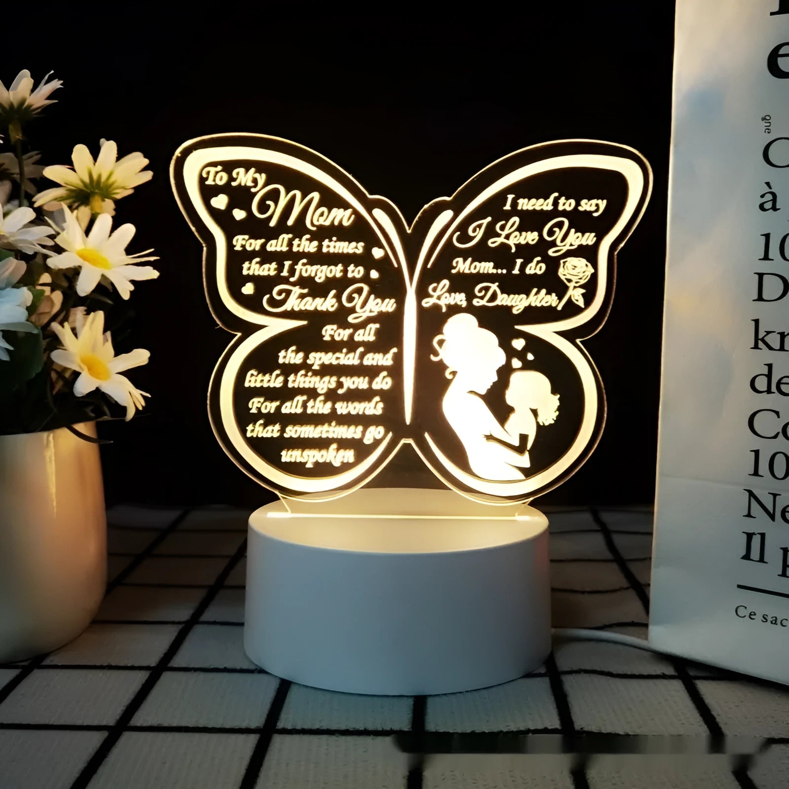 White heart-shaped acrylic table lamp with USB cable and touch-sensitive base on a wooden desk.