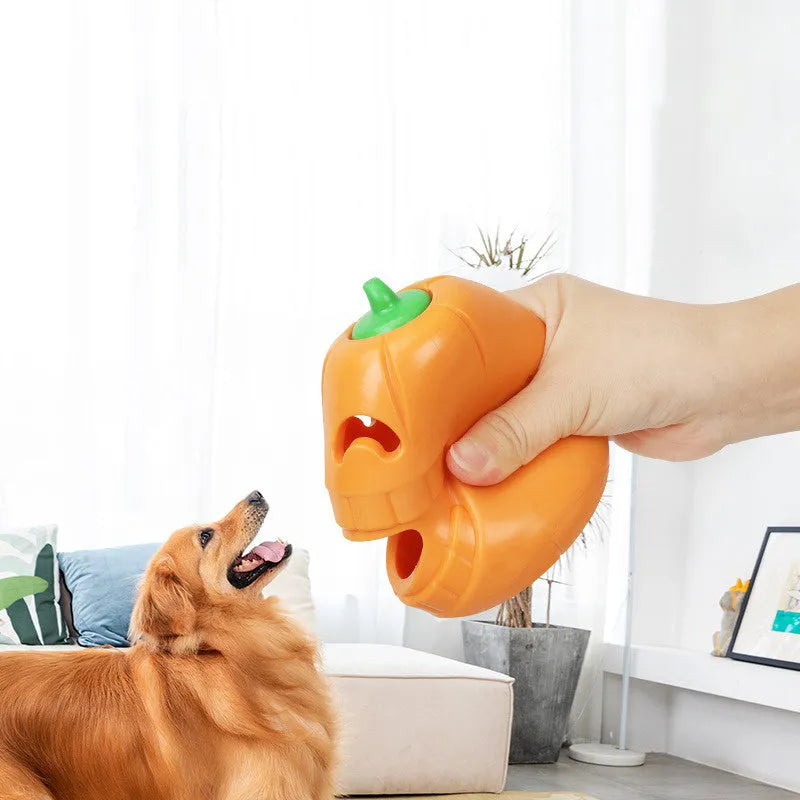 Orange Halloween pumpkin shaped dog chew toy with a funnel opening for treats.